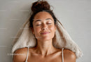 Relaxed Freckled Woman Smiling with Closed Eyes in Cozy Setting