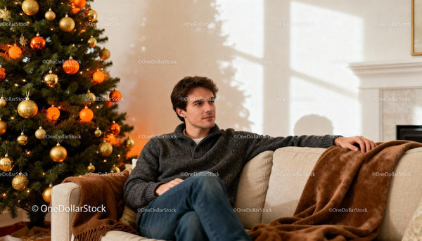 Man relaxing at home near decorated Christmas tree