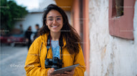 Young Woman Enjoying Photography Outdoors with Camera and Tablet