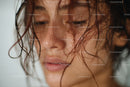 Close-up Portrait of a Wet-Haired Woman Expressing Emotive Intensity