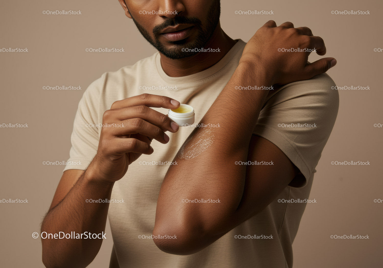 Man Applying Body Lotion to Shoulder for Moisturizing and Skin Care