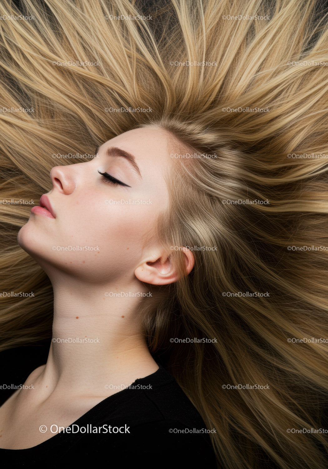 Side profile of calm woman with flowing blonde hair