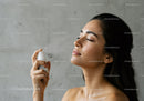 Woman Applying Facial Mist for Hydration and Skin Care