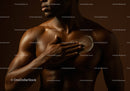 Elegant Dark-Skinned Woman Applying Body Lotion for Skincare Routine