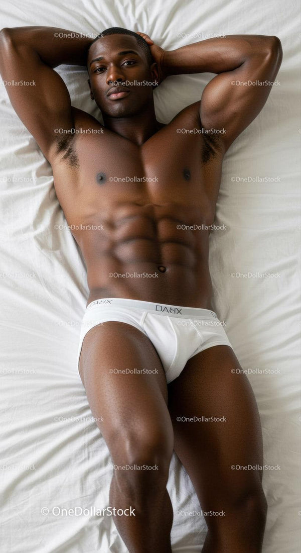 Fit man relaxing on bed in white briefs