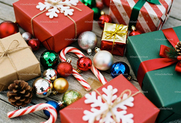 Christmas gifts and decorations on rustic wooden floor