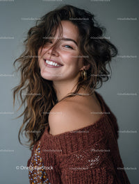 Joyful Woman with Curly Hair Wearing Rust Sweater and Gold Earrings