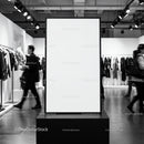 Blank vertical poster frame in modern clothing store