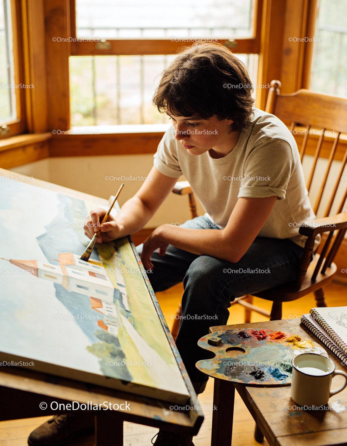 Young artist painting serene landscape with watercolors