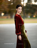 Elegant woman with velvet dress in autumn park