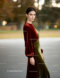 Elegant woman with velvet dress in autumn park