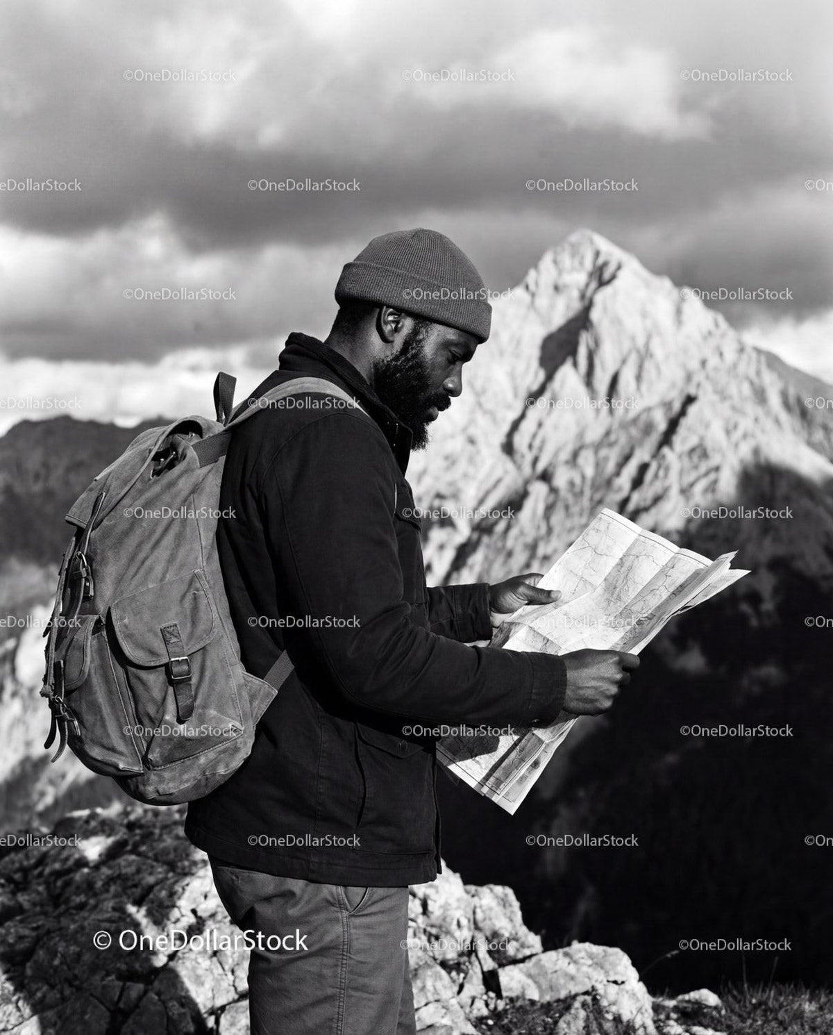 Explorer Studying Map on Rocky Mountain Peak