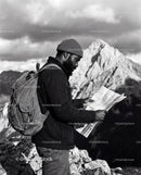 Explorer Studying Map on Rocky Mountain Peak