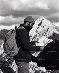 Explorer Studying Map on Rocky Mountain Peak