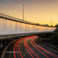 Modern Highway Overpass with Light Trails and Sunset Sky