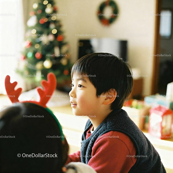 Young Asian boy enjoying Christmas morning indoors
