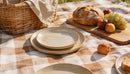 Cozy outdoor picnic setup with bread and fresh fruit