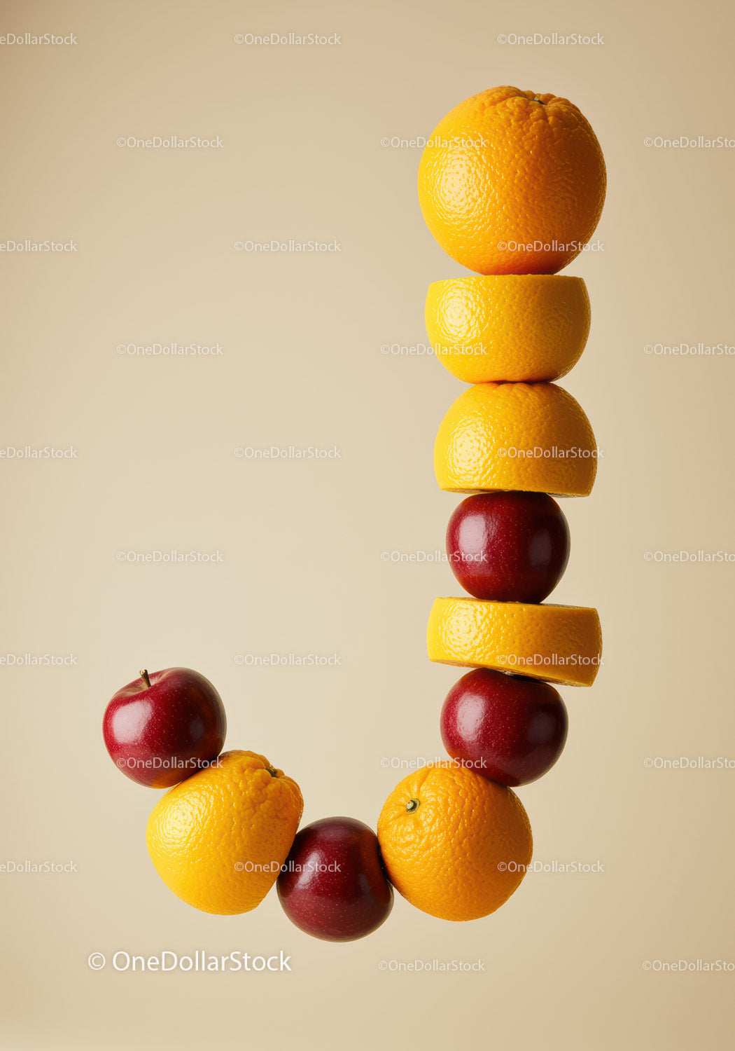 Creative letter J made of fresh apples and oranges
