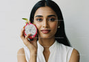 Portrait of a Woman Holding a Dragon Fruit with Bright Natural Lighting