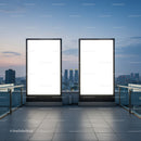 Blank illuminated billboards on rooftop with city skyline