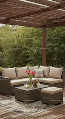 Elegant Outdoor Patio with Wicker Sofa and Pink Tulips in Garden