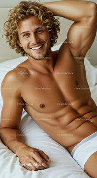 Smiling young man relaxing on bed in white underwear