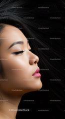 Close up portrait of serene woman with flowing black hair