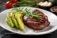 Grilled Steak with Avocado Slices and Fresh Rosemary on White Plate