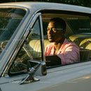 Young Man in Pink Shirt Sitting in Vintage Car on a Sunny Day