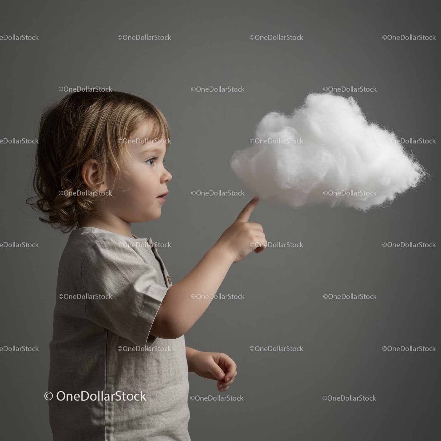 Toddler Touching Soft White Cloud on Gray Background