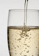 Close up of sparkling drink being poured into glass