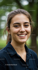 Joyful Young Woman Smiling Outdoors with Nature Background