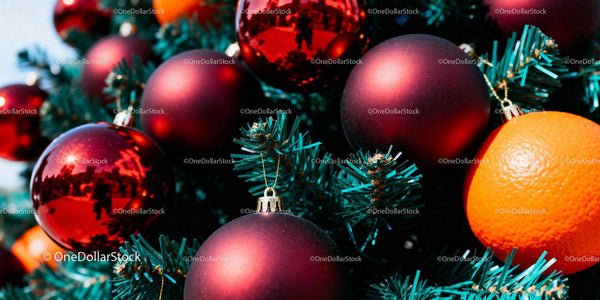 Close-up of Christmas Tree with Red Ornaments and Orange