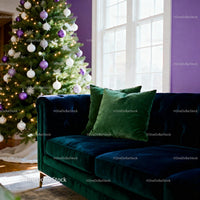 Cozy living room with velvet sofa and decorated Christmas tree