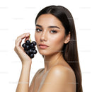 Elegant Portrait of Woman Holding Fresh Black Grapes with Flawless Skin