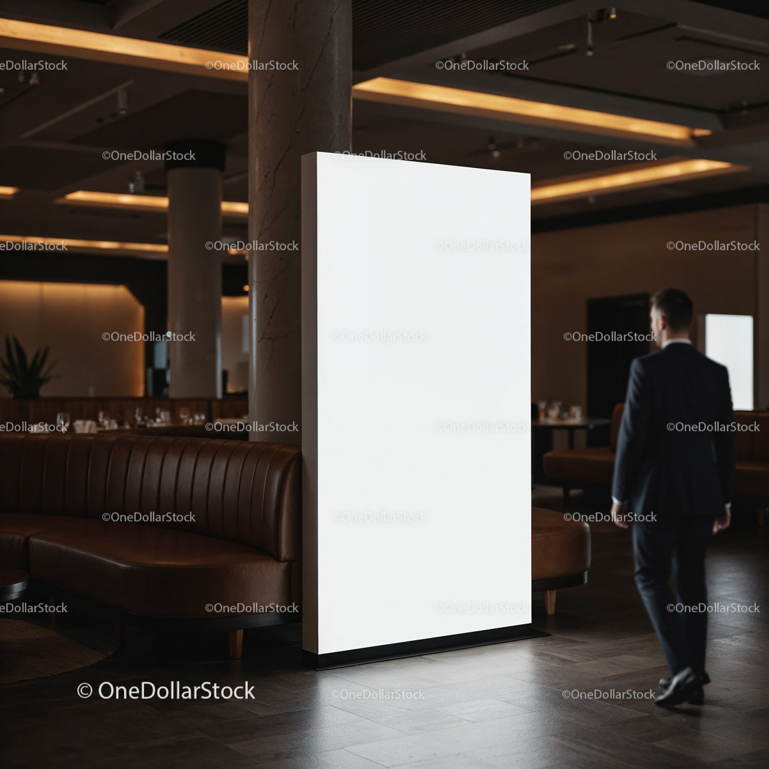 Man walking past illuminated blank advertising display indoors