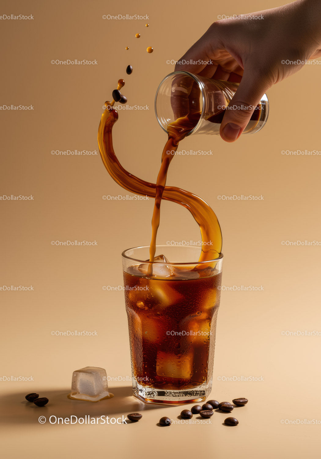 Hand pouring cold brew coffee over ice cubes