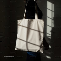 Person Holding Plain Tote Bag in Soft Window Light