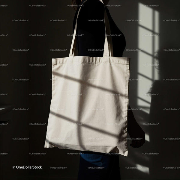 Person Holding Plain Tote Bag in Soft Window Light JPG Mockup Image