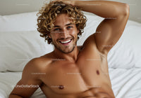 Smiling young man relaxing shirtless on bed
