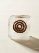 Mint Candy Encased in Clear Ice Cube on Light Surface