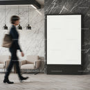 Businesswoman walking past empty black frame in lobby