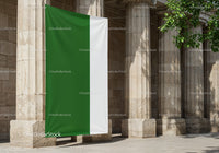 Green and White Flag Hanging Outside Classic Stone Columns