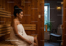 Relaxing Woman in Wooden Sauna with Towel and Cozy Atmosphere