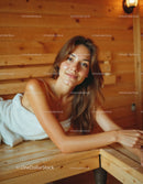 Relaxed Woman Lying on Wooden Bed in Cozy Interior