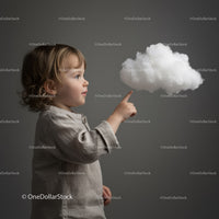 Toddler interacting with a floating soft cloud shape