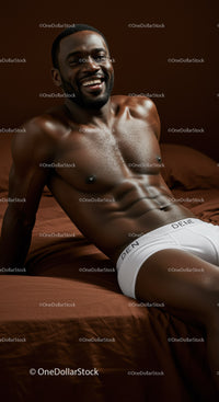 Smiling muscular man relaxing on brown bed linens