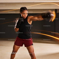 Focused woman boxing with intensity in training gym