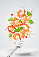 Fresh shrimp with basil and red pepper splash over plate