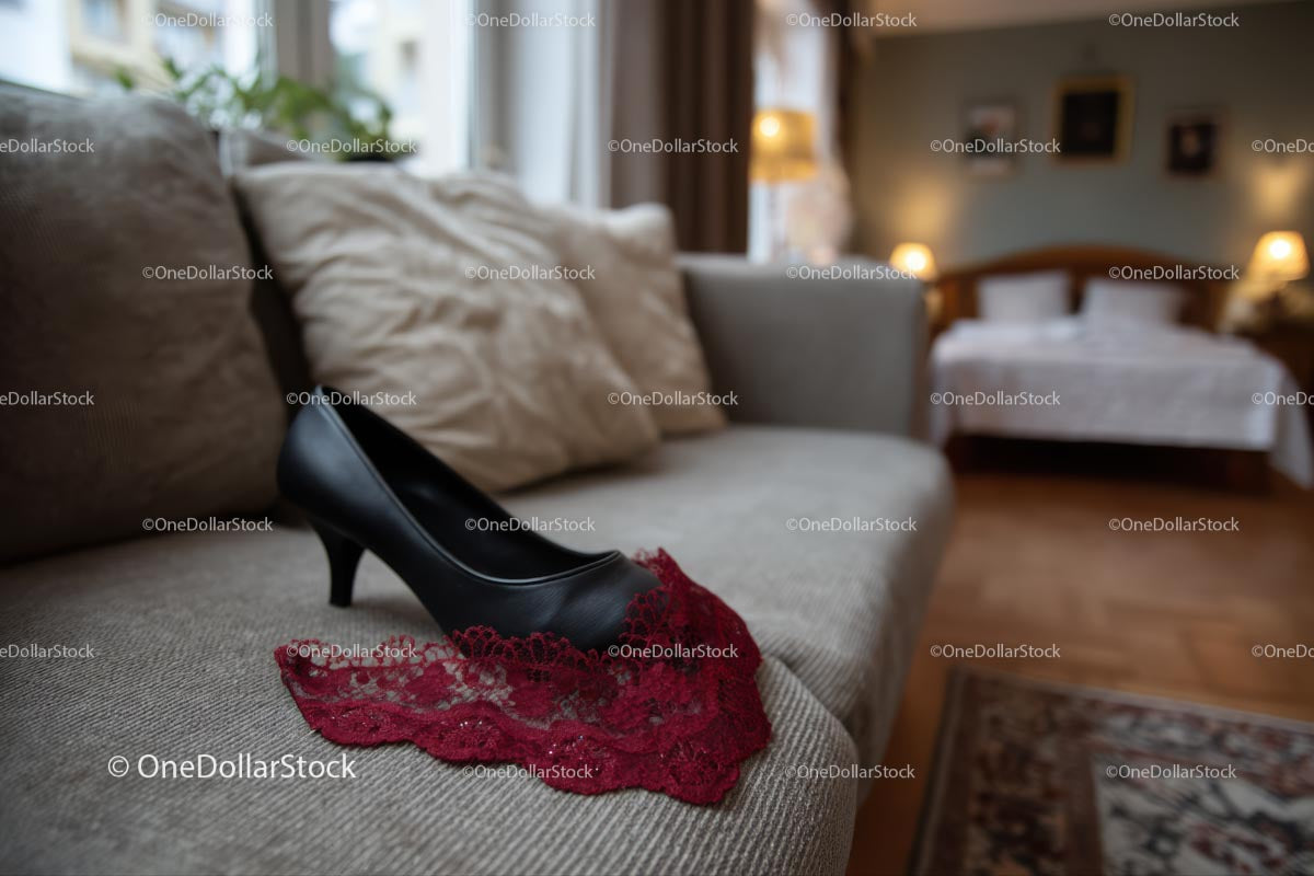 Chic Black Heels and a Red Lace Dress in a Cozy Bedroom Setting